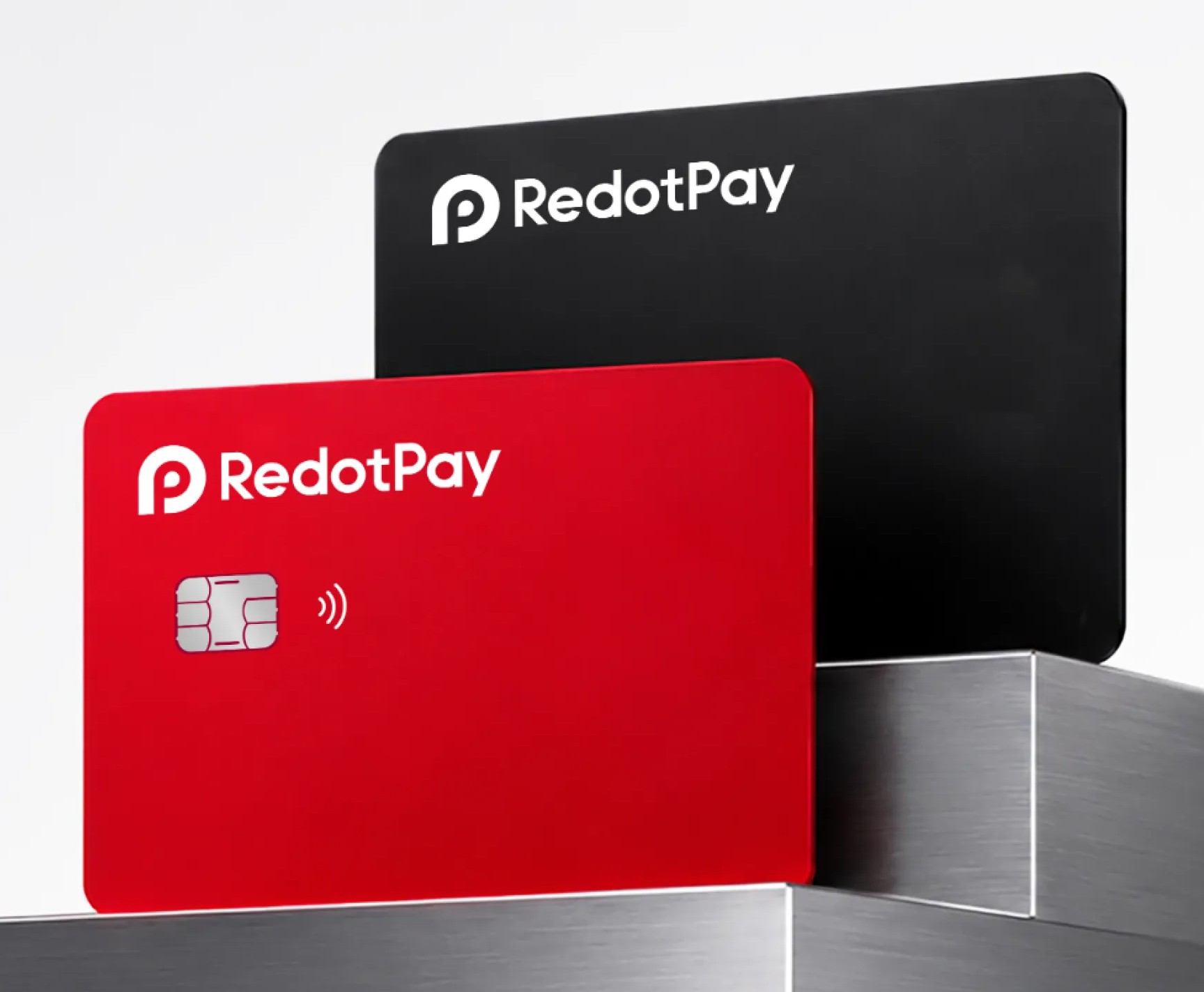 RedotPay 官方卡片产品图：红色实体卡（左，带 EMV 芯片与感应标识）与黑色虚拟卡（右），卡面均压印 RedotPay 标志